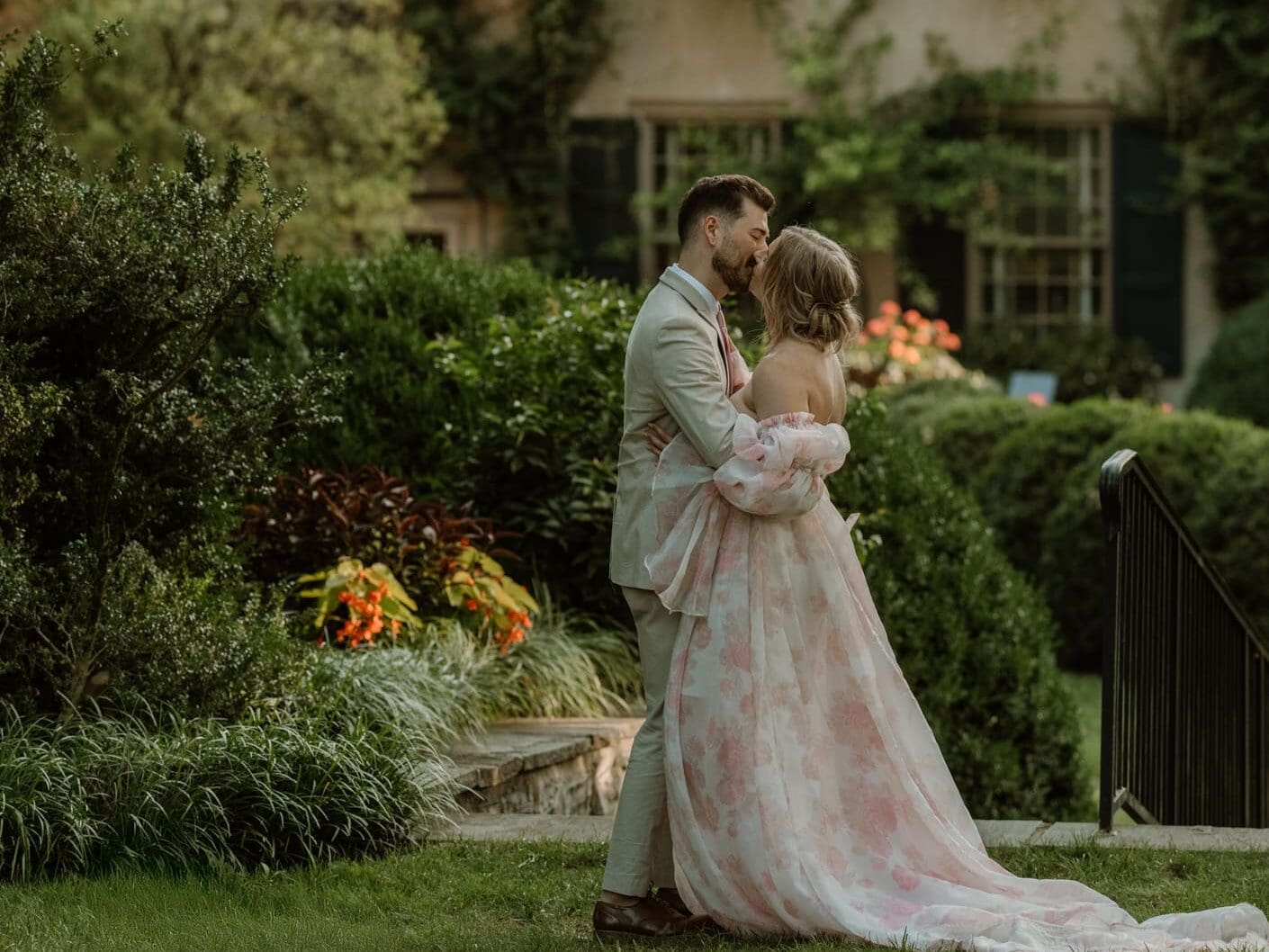 Romantic portrait of a couple embracing in the gardens of Conestoga House and Gardens, a historic estate wedding venue in Lancaster, Pennsylvania.